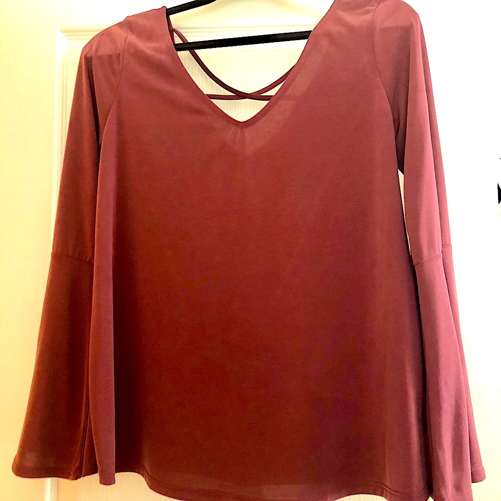 New Designer flowing l/S top. With crisscross back